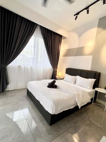 a bedroom with a bed with a teddy bear on it at Imperio Residences Private Bathtub or Jacuzzi by Nestcove in Melaka