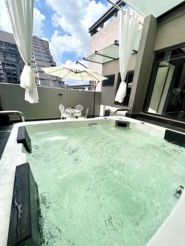 a hot tub on the balcony of a house at Imperio Residences Private Bathtub or Jacuzzi by Nestcove in Melaka