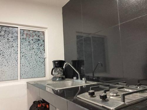 a kitchen with a sink and a window at Depa wifi en corredor de balnearios in Ixmiquilpan