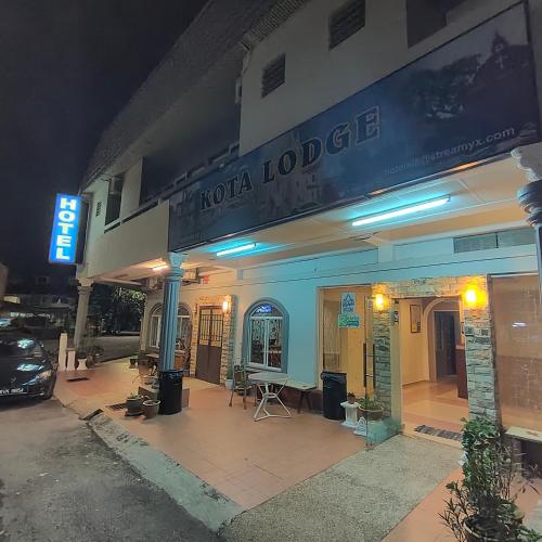 a hotel with a sign on the front of it at Kota Lodge Guest House in Melaka