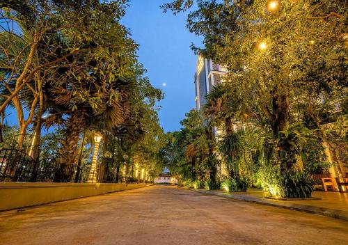 an empty street with trees and a building at Kampot View Boutique in Kampot