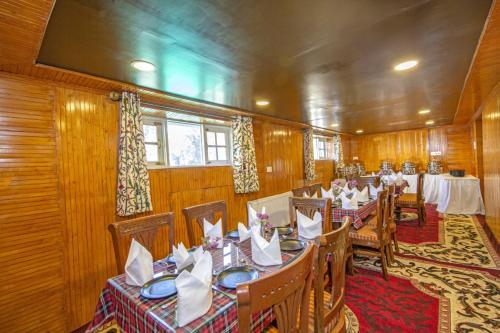 a dining room with tables and chairs in it at Gulmarg Ski Hill Resort in Gulmarg
