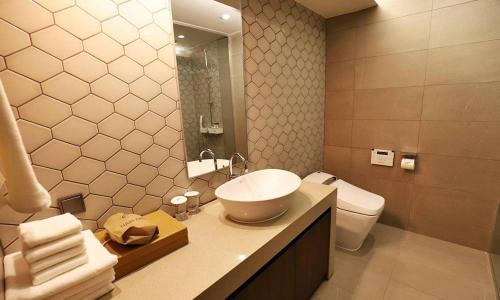 a bathroom with a sink and a toilet at Gangneung Grey Hotel in Gangneung