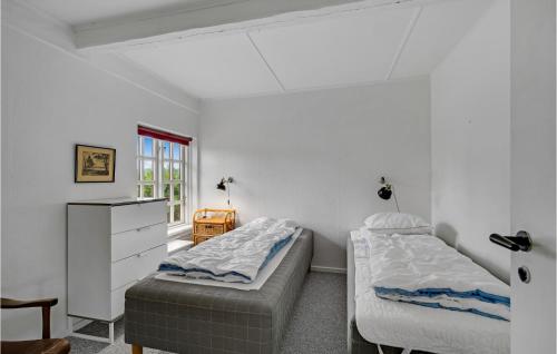 two beds in a room with white walls at Nice Home In Kvrndrup With 6 Bedrooms And Wifi in Kværndrup