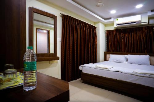a bottle of water sitting on a table in a bedroom at Hotel Sea Land in Kanyakumari