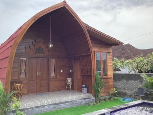a small wooden house with a large door at THE JINENG,S SANUR in Sanur
