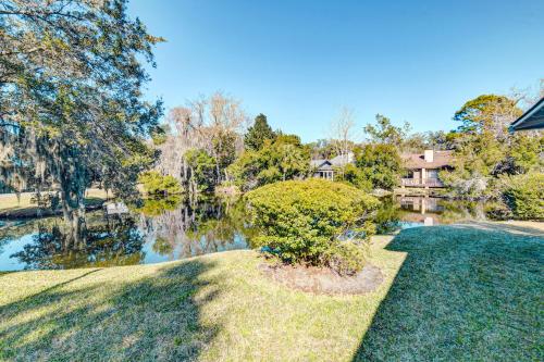 an estate with a pond in front of a house at Golf Villa Getaway in Harrington