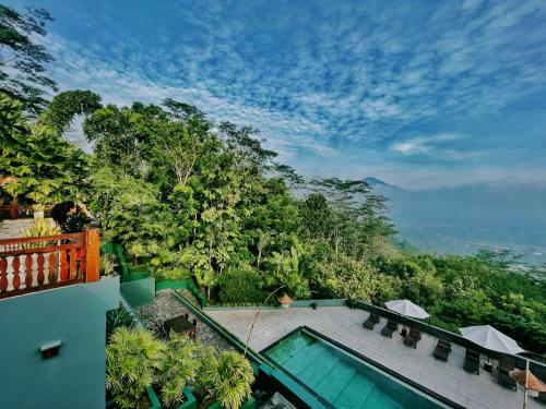 a view of a swimming pool from a house at Villa Borobudur Resort in Borobudur