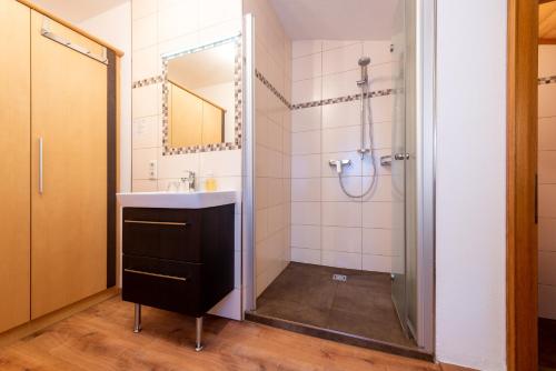 a bathroom with a sink and a shower at Energiepension Schwaiger in Leogang