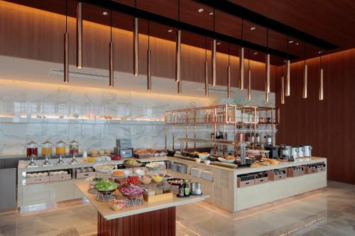 a large kitchen with a bunch of food in it at Candeo Hotel Utsunomiya in Utsunomiya