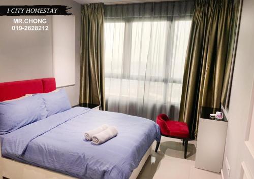um quarto com uma cama e uma cadeira vermelha em I City Suite With Wifi em Shah Alam