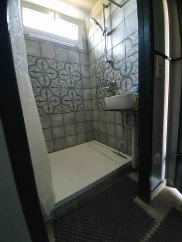 a small bathroom with a sink and a shower at Kaimo turizmo sodyba Satavi in Kintai