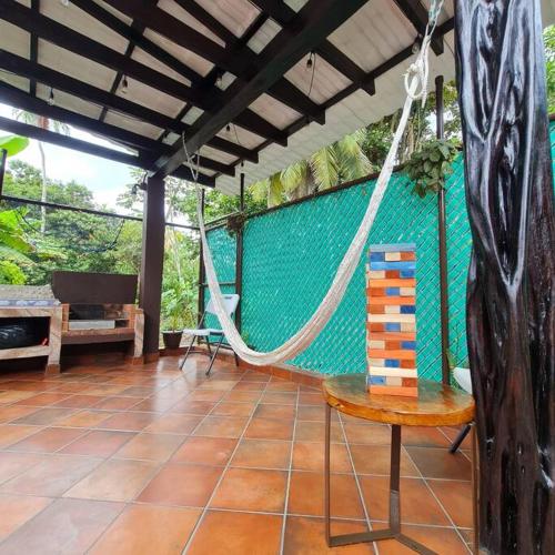 a porch with a hammock and a blue wall at Casa-cabaña Jefe Indio /Playa Cacique in Cacique