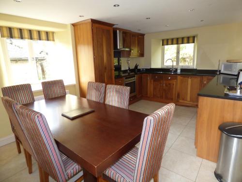 a kitchen with a wooden dining room table and chairs at Clifton Cottage at Lovelady Shield in Alston