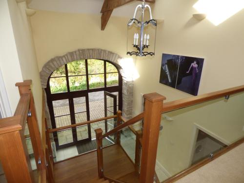 a staircase with an archway in a house at Clifton Cottage at Lovelady Shield in Alston