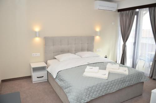 una camera da letto con un grande letto con due asciugamani di Bóris House a Ognyanovo
