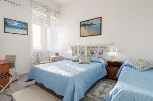 Postel nebo postele na pokoji v ubytování Affittacamere AioSardegna al Porto