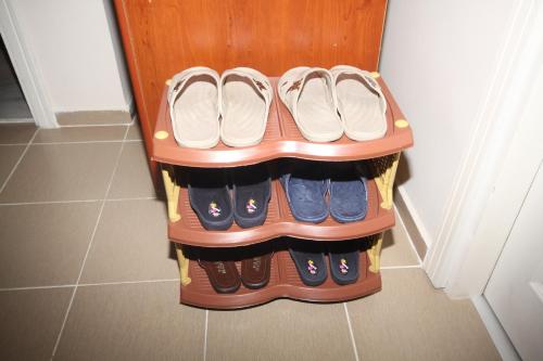 a rack of shoes in a closet at Sari Pension in Edirne