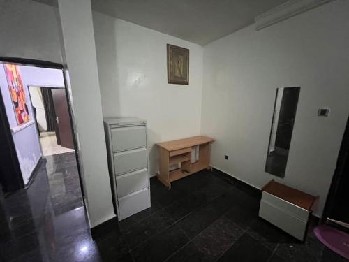 アブジャにあるGreat 3 bedroom Apartment in the city centerのデスクとテーブルが備わる客室です。