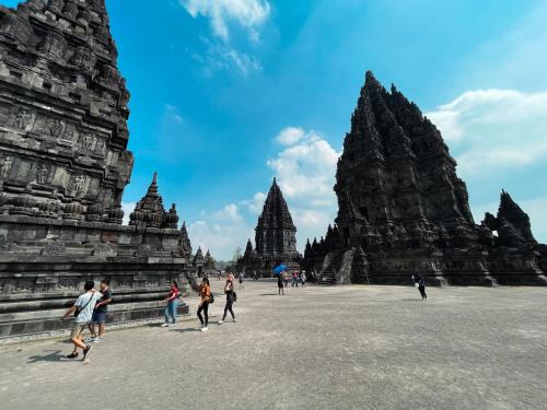 a group of people walking around a temple at Villa Borobudur Resort in Borobudur