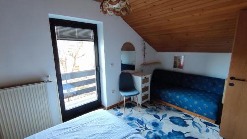 a bedroom with a bed and a desk and a window at Apartments Kapus Center in Bled