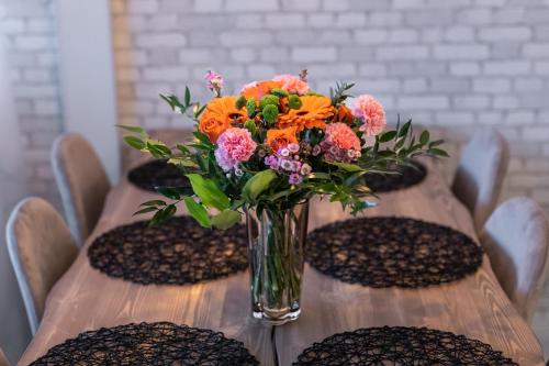 a vase of flowers sitting on top of a table at City Garden Apartments 2 in Rovaniemi