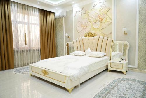 a bedroom with a bed with a flower mural on the wall at Казахстан 13 in Tashkent