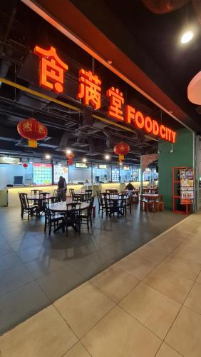 a restaurant with tables and chairs and a sign that reads foodocity at Ai Smart Home , Bangsar South in Kuala Lumpur