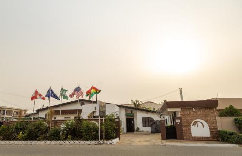 a row of flags in front of a building at Hill View Hotel West Airport in Accra