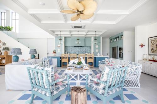 a living room with a table and chairs at Umbala the house in Canggu