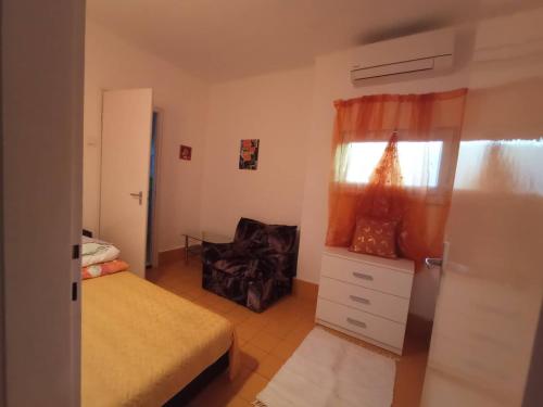 a bedroom with a bed and a chair in it at Mária Villa in Fonyód