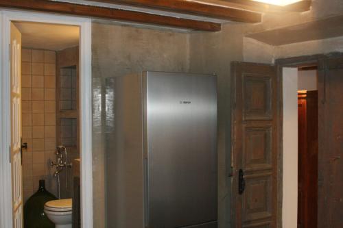 a kitchen with a stainless steel refrigerator in a bathroom at Matsas Mansions in Chora Folegandros