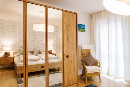 a bedroom with a bed and a mirror at Weinbau Frank Schönig in Sommerhausen