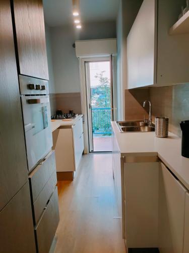 a kitchen with a sink and a stove top oven at Casa Il Delfino in Aci Castello