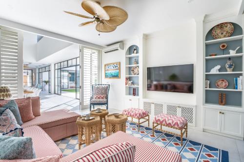 a living room with a couch and a tv at Umbala the house in Canggu