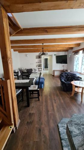 a living room with a couch and a table at Chalupa u rybára s Wellness a detským ihriskom in Liptovský Trnovec