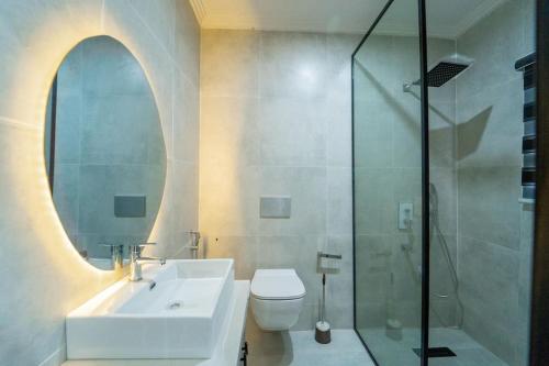 a bathroom with a sink and a toilet and a shower at Luxury Condo in Ikoyi (banana Island) in Araromi