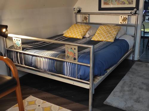 a pair of bunk beds with blue and yellow pillows at Le studio d'Evelyne in Dieppe
