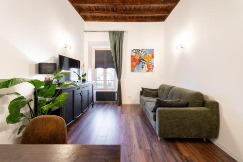 a living room with a couch and a chair at Appartamento trastevere Roma in Rome