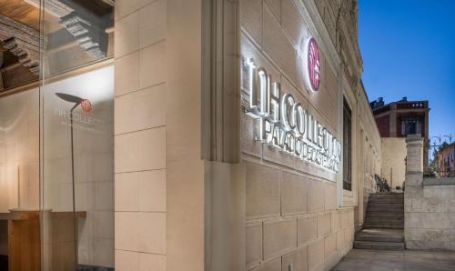 a building with a sign on the side of it at NH Collection Salamanca Palacio de Castellanos in Salamanca