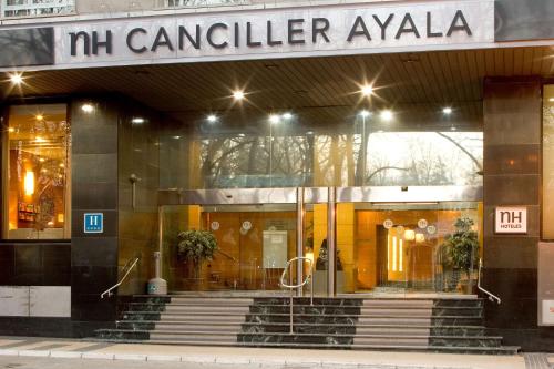 a building with stairs in front of a store at NH Canciller Ayala Vitoria in Vitoria-Gasteiz
