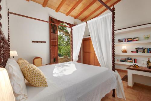a bedroom with a bed and a window at Agroturisme Perola - Only Adults in Llucmajor