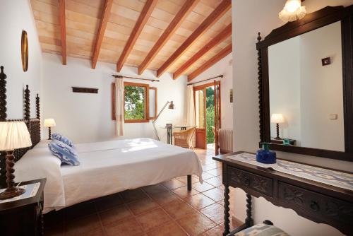 a bedroom with a bed and a large mirror at Agroturisme Perola - Only Adults in Llucmajor