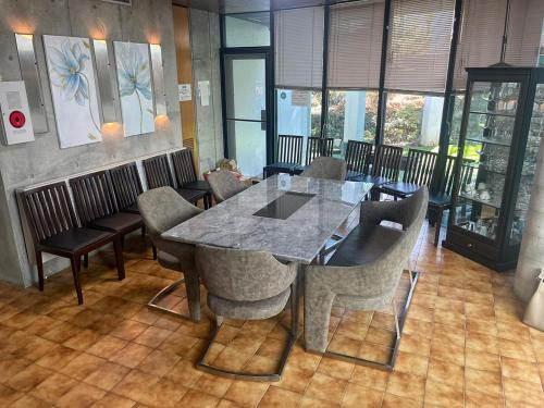a dining room with a table and chairs at 24時間源泉掛け流しGuest House Belle Hakone in Hakone