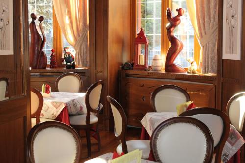 a dining room with two tables and chairs and a window at Grand Hotel Principe in Limone Piemonte