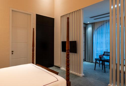 a bedroom with a bed and a desk at The Earth Amritsar, Trademark Collection by Wyndham in Amritsar