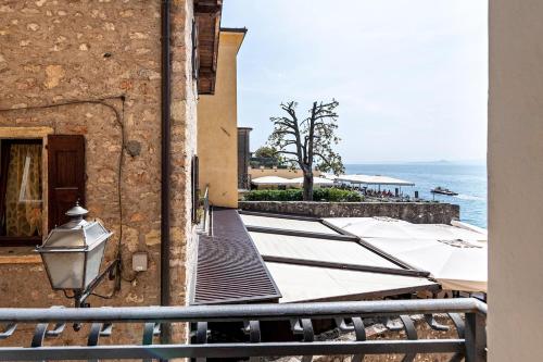 a view of the ocean from a building at ApartmentsGarda - Residenza Dei Navigatori in Torri del Benaco