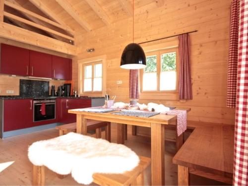a wooden kitchen with a wooden table in a cabin at Chalet Chiemgau in Schleching