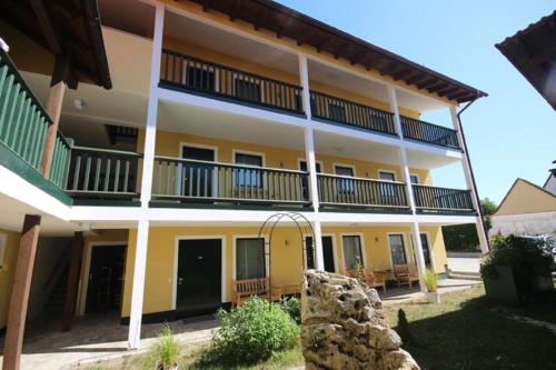 a large yellow building with balconies on it at Gasthof Ehrl in Essing