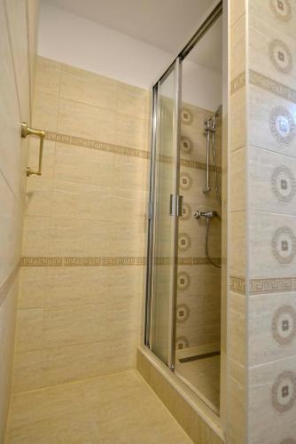 a shower with a glass door in a bathroom at Otilia in Bucharest